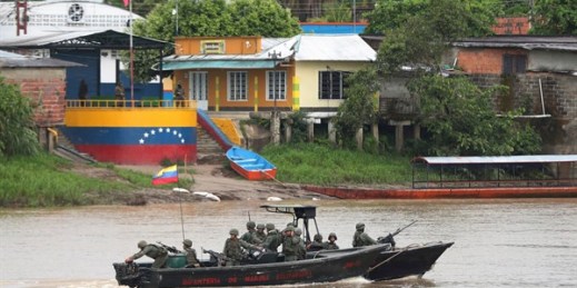 Venezuelan navy soldiers patrol the Arauca River, the natural border with Colombia, seen from Arauquita, Colombia, March 26, 2021 (AP photo by Fernando Vergara).