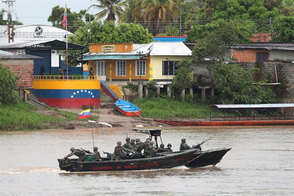 Venezuelan navy soldiers patrol the Arauca River, the natural border with Colombia, seen from Arauquita, Colombia, March 26, 2021 (AP photo by Fernando Vergara).