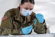 A U.S. Army medic fills syringes with the Johnson & Johnson COVID-19 vaccine in North Miami, Fla., March 3, 2021 (AP photo by Marta Lavandier).