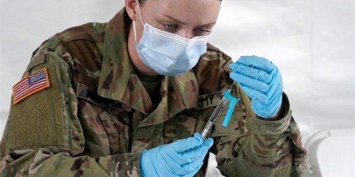 A U.S. Army medic fills syringes with the Johnson & Johnson COVID-19 vaccine in North Miami, Fla., March 3, 2021 (AP photo by Marta Lavandier).