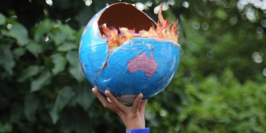 A girl holds a globe at a climate change protest in Mumbai, India, Sept. 27, 2019 (AP photo by Rafiq Maqbool).