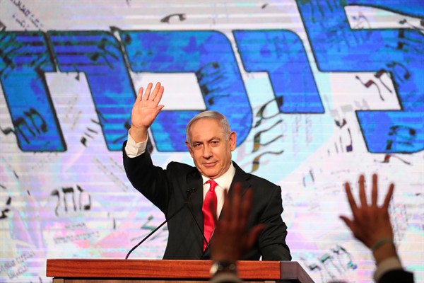 Israeli Prime Minister Benjamin Netanyahu waves to supporters after the first exit poll results for the Israeli parliamentary elections, at the Likud party’s headquarters in Jerusalem, March. 24, 2021 (AP photo by Ariel Schalit).