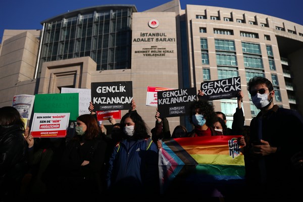 Bogazici University students hold an LGBT flag and a placard that reads “the youth will win” at a protest in support of their detained friends in Istanbul, Feb. 3, 2021 (AP photo by Emrah Gurel).