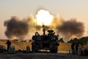 An Israeli artillery unit fires shells