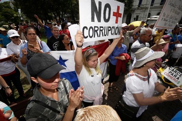 A protester holds up a sign that reads in Spanish, “No more corruption,” during a demonstration outside the attorney general’s office in Panama City, Panama, Jan. 23, 2018 (AP photo by Arnulfo Franco).