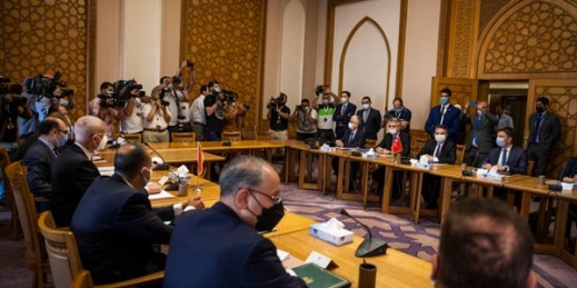 Turkey’s deputy foreign minister, Sedat Onal, seated second right, and his Egyptian counterpart Hamdi Sanad Loza, fourth left, and their delegations, in Cairo, Egypt, May 5, 2021 (AP photo by Nariman El-Mofty).