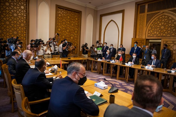 Turkey’s deputy foreign minister, Sedat Onal, seated second right, and his Egyptian counterpart Hamdi Sanad Loza, fourth left, and their delegations, in Cairo, Egypt, May 5, 2021 (AP photo by Nariman El-Mofty).