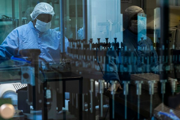 An employee works on the production of AstraZeneca vaccines for COVID-19 at the Fiocruz Foundation in Rio de Janeiro, Brazil, Feb. 12, 2021 (AP photo by Bruna Prado).