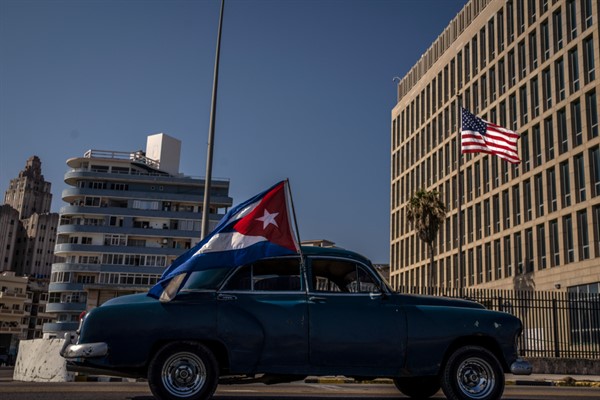 A car flying a Cuban flag drives past the American embassy during a rally calling for the end of the U.S. blockade against the island nation, Havana, Cuba, March 28, 2021 (AP photo by Ramon Espinosa).