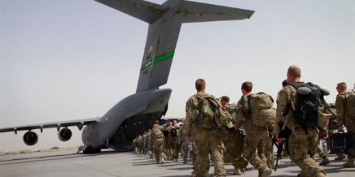 U.S. soldiers walk toward an American military plane as they leave Afghanistan, at the U.S. base in Bagram, north of Kabul, Afghanistan, July 14, 2011 (AP photo by Musadeq Sadeq).