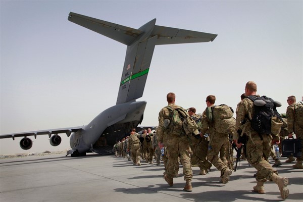 U.S. soldiers walk toward an American military plane as they leave Afghanistan, at the U.S. base in Bagram, north of Kabul, Afghanistan, July 14, 2011 (AP photo by Musadeq Sadeq).