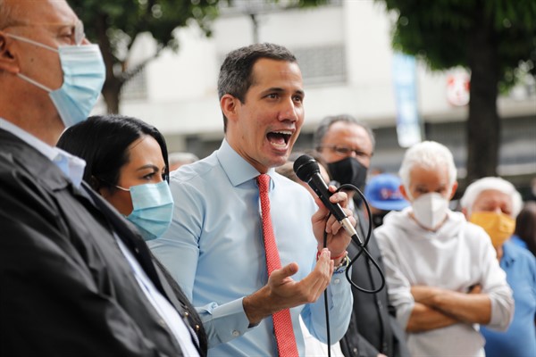 Flanked by party members, Venezuelan opposition leader Juan Guaido speaks a day after parliamentary elections, in Caracas, Venezuela, Dec. 7, 2020 (AP photo by Ariana Cubillos).