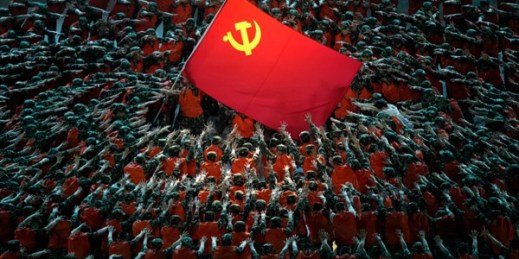 Performers dressed as rescue workers gather around the Communist Party flag during a gala show ahead of the 100th anniversary of the founding of the Chinese Communist Party in Beijing, June 28, 2021 (AP photo by Ng Han Guan).