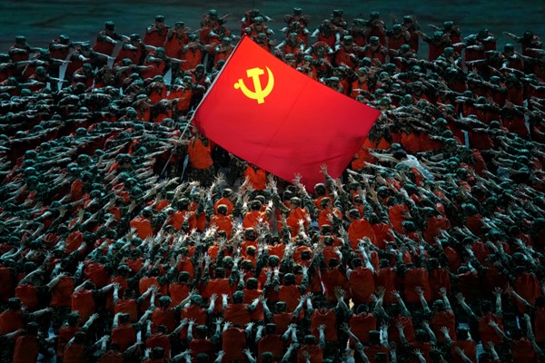 Performers dressed as rescue workers gather around the Communist Party flag during a gala show ahead of the 100th anniversary of the founding of the Chinese Communist Party in Beijing, June 28, 2021 (AP photo by Ng Han Guan).