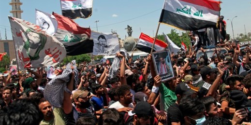 Anti-government protesters try to force their way into the Green Zone area in Baghdad, Iraq, May 25, 2021 (AP photo by Khalid Mohammed).