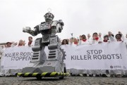 Protesters take part in a Campaign to Ban Killer Robots demonstration in front of the Brandenburg Gate, in Berlin, Germany, March 21, 2019 (Photo by Wolfgang Kumm for dpa via AP Images).