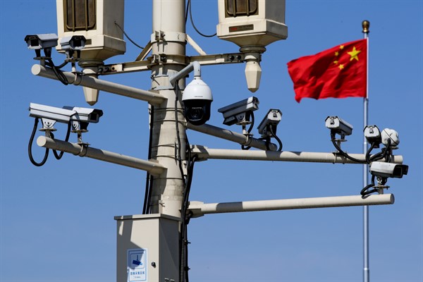 A Chinese national flag near the surveillance cameras in Tiananmen Square, Beijing, March 15, 2019 (AP photo by Andy Wong).