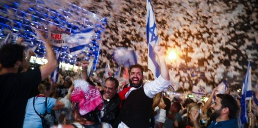 People celebrate the swearing-in of the new government in Tel Aviv, Israel, June 13, 2021 (AP photo by Oded Balilty).
