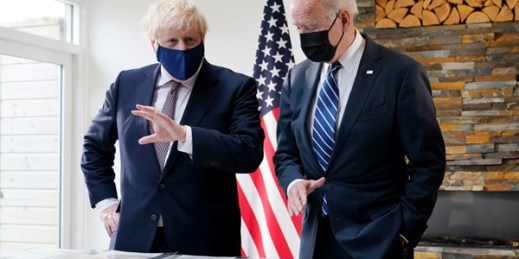 President Joe Biden and British Prime Minister Boris Johnson look at copies of the Atlantic Charter during a bilateral meeting ahead of the G-7 summit, in Carbis Bay, England, June 10, 2021 (AP photo by Patrick Semansky).