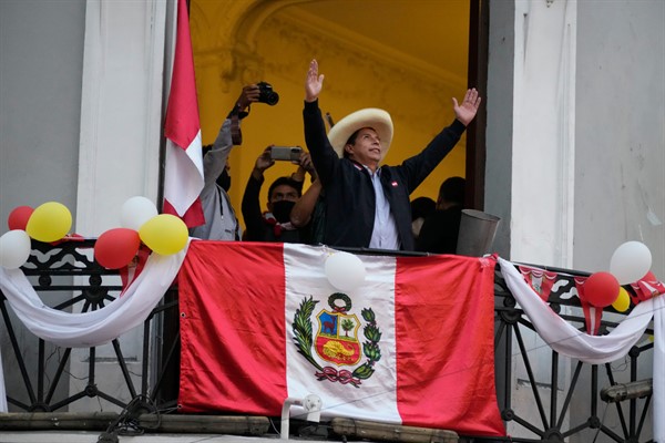 Presidential candidate Pedro Castillo greets supporters at his campaign headquarters the day after a runoff election, in Lima, Peru, June 7, 2021 (AP photo by Martin Mejia).