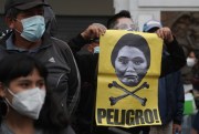 A man holds a poster that says “Danger!” in Spanish, during a protest against the presidential candidacy of Keiko Fujimori, in Lima, Peru, May 22, 2021 (AP photo by Martin Mejia).