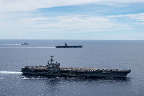 The USS Ronald Reagan and USS Nimitz Carrier Strike Groups sail together in formation, in the South China Sea, July 6, 2020 (Photo by Mass Communication Specialist 3rd Class Jason Tarleton for U.S. Navy via AP Images).