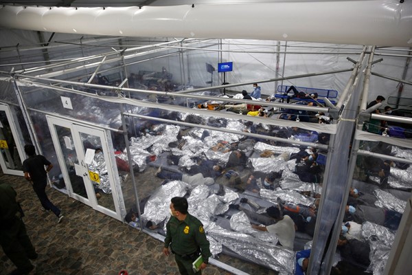 Young minors lie inside a pod at a detention center for unaccompanied children run by U.S. Customs and Border Protection in Donna, Texas, March 30, 2021 (AP photo by Dario Lopez-Mills).