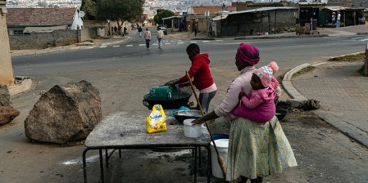 Women pack up their roadside food stall in Alexandra Township, north of Johannesburg, South Africa, July 15 2021 (AP photo by Ali Greeff).