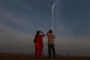 Indians watch a rocket carrying communication satellite GSAT-29 lift off from Satish Dhawan Space Center in Sriharikota, India, Nov. 14, 2018 (AP Photo/R. Parthibhan).