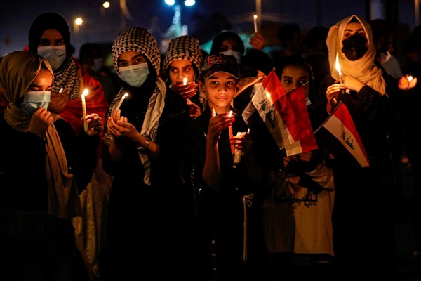 Demonstrators light candles to mark the first anniversary of the anti-government protests in Basra, Iraq, Oct. 1, 2020 (AP photo by Nabil al-Jurani).