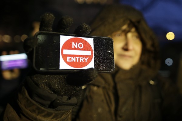 A demonstrator protesting against the court order requiring Apple to make it easier for the FBI to unlock an encrypted iPhone used by a gunman in the December 2015 San Bernardino terrorist attack, Feb. 23, 2016, in New York (AP photo by Julie Jacobson).