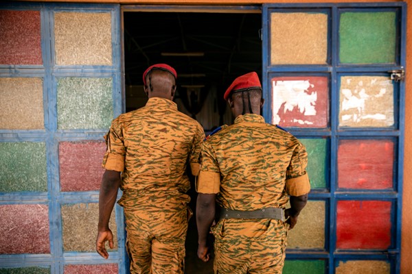 Two soldiers enter the Catholic church at the 10th RCAS army barracks in Kaya, Burkina Faso, April 10, 2021 (AP photo by Sophie Garcia).