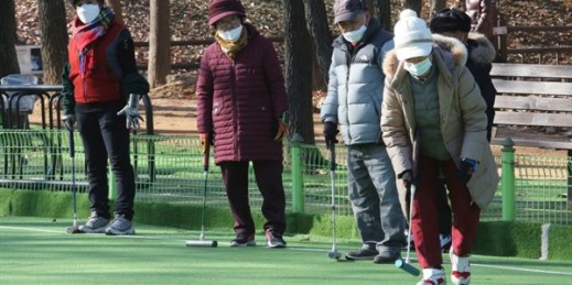 A group of elderly people play gate ball at a park in Goyang, South Korea, Nov. 28, 2020 (AP photo by Ahn Young-joon).