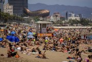 Sunbathers on the beach in Barcelona, Spain, July 9, 2021 (AP photo by Joan Mateu).