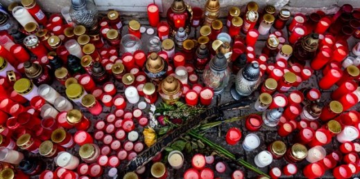 Candles and a ribbon with the inscription “Roma lives matters” on the sidewalk where Stanislav Tomas died, in Teplice, Czech Republic, June 24, 2021 (CTK photo by Ondrej Hajek via AP).