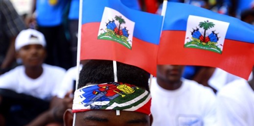 Students wearing Haitian national flags wait for the start of a parade marking Flag Day, in Port-au-Prince, Haiti, May 18, 2019 (AP photo by ).