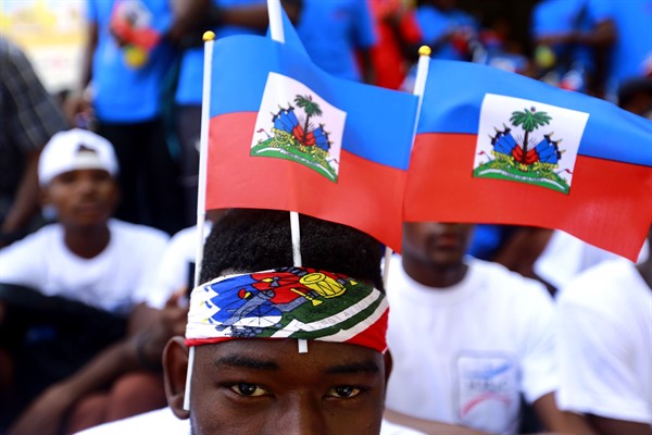 Students wearing Haitian national flags wait for the start of a parade marking Flag Day, in Port-au-Prince, Haiti, May 18, 2019 (AP photo by ).