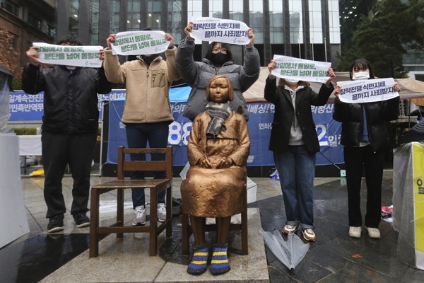 Protesters hold a rally to mark the March First Independence Movement against Japanese colonial rule by a statue symbolizing a wartime “comfort woman” near the Japanese Embassy in Seoul, South Korea, March 1, 2021 (AP photo by Ahn Young-joon).