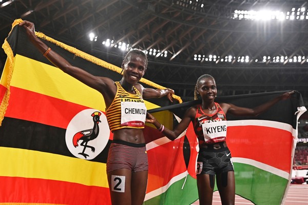 Uganda’s Peruth Chemutai, left, and Kenya’s Hyvin Kiyeng celebrate after Chemutai won gold and Kiyeng won silver in the women’s 3,000-meter steeplechase final at the 2020 Summer Olympics in Tokyo, Japan, Aug. 4, 2021 (AP photo by Ben Stansall).