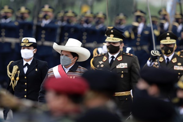 Peruvian President Pedro Castillo reviews the honor guard as he arrives for a military parade in Lima, Peru, July 30, 2021 (AP photo by Guadalupe Pardo).