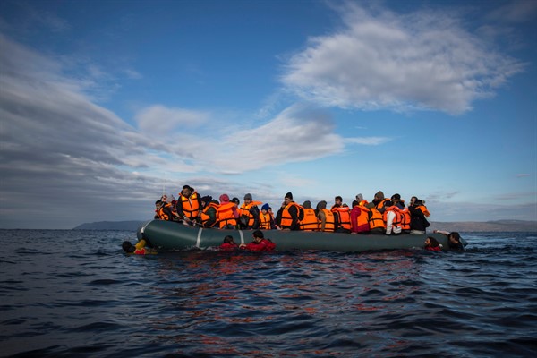 Refugees and migrants arrive on an inflatable vessel from the Turkish coast to the northeastern Greek island of Lesbos, Dec. 3, 2015 (AP photo by Santi Palacios).