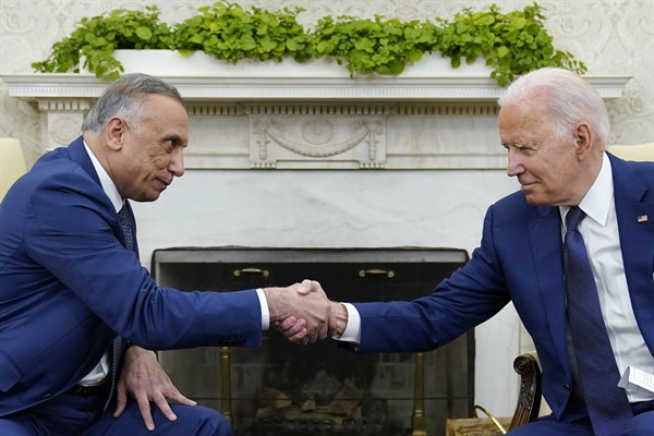 U.S. President Joe Biden shakes hands with Iraqi Prime Minister Mustafa al-Kadhimi during their meeting in the Oval Office of the White House in Washington, July 26, 2021 (AP photo by Susan Walsh).