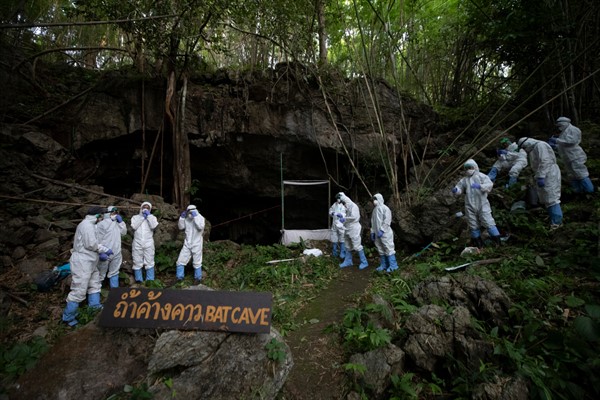 Researchers stand in front of a cave entrance as they prepare to catch bats, at Sai Yok National Park, Kanchanaburi province, Thailand, July 31, 2020 (AP photo by Sakchai Lalit).