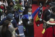 Elisa Loncon, president of the Constituent Assembly, raises an Indigenous Mapuche flag during the inaugural session of the Constitutional Convention in Santiago, Chile, July 4, 2021 (AP photo by Esteban Felix).