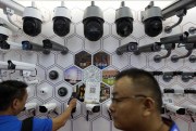Visitors look at surveillance cameras made by China’s telecoms equipment giant Huawei on display at the China Public Security Expo in Shenzhen, Guangdong province, Oct. 29, 2019 (AP photo by Andy Wong).
