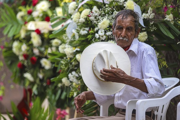 Victor Ruiz Valencia removes his hat during the burial of his cousin, Yaqui Indigenous rights leader Tomas Rojo, who was found dead amid local opposition to construction in the area, in Vicam, Sonora state, Mexico, July 10, 2021 (AP photo/Luis Gutierrez).