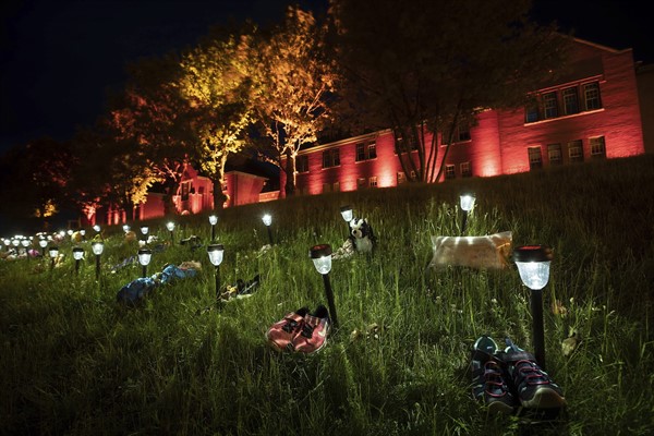 Shoes are placed outside the former Kamloops Indian Residential School to honor the 215 children whose unmarked graves were discovered near the facility, in Kamloops, British Columbia, June 4, 2021 (Photo by Darryl Dyck for the Canadian Press via AP).