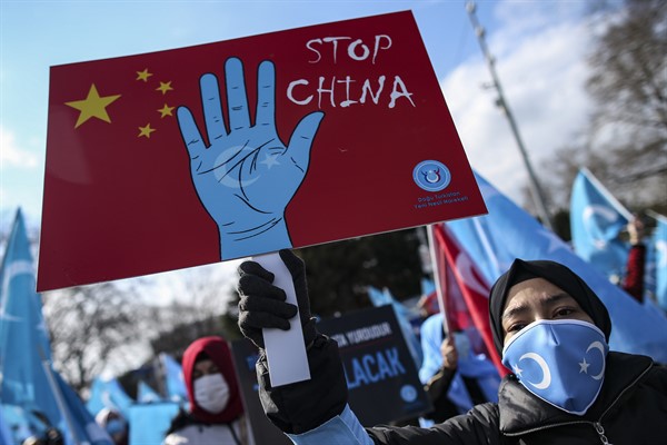 A protester from the Uyghur community living in Turkey holds a placard during a protest in Istanbul, March 25, 2021 (AP photo by Emrah Gurel).