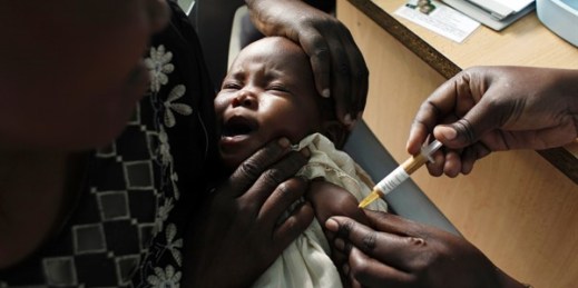 A mother holds her baby receiving a malaria vaccine as part of a trial at the Walter Reed Project Research Center in Kombewa, western Kenya, Oct. 30, 2009 (AP photo by Karel Prinsloo).