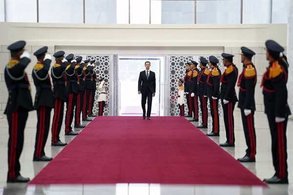 Syrian President Bashar Assad reviews an honor guard at the Syrian Presidential Palace in Damascus, Syria, July 17, 2021 (photo by the Syrian Presidency via Facebook via AP).